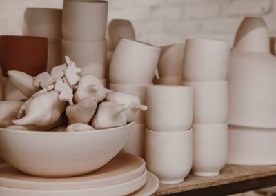 A close-up view of handmade ceramic pottery and craft pieces in a minimalist style.